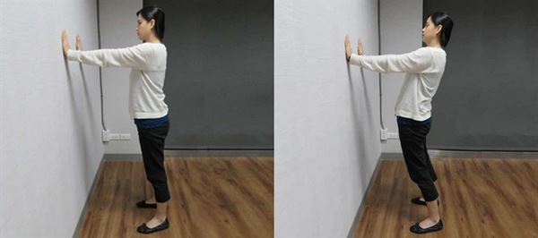 面向牆壁，慢慢地將腰部往前挺，維持2、3秒後，再回到直立姿勢。（攝影／洪毓琪）